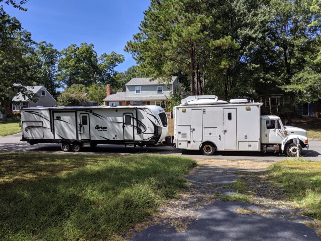 Office truck towing a camper